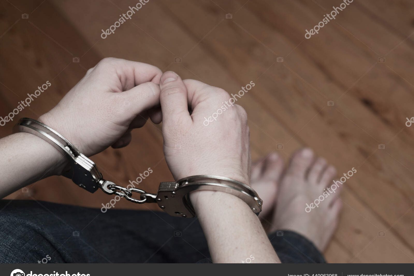 Man detained in handcuffs. Prisoner or arrested man in handcuffs. Male hands in handcuffs. Criminal law