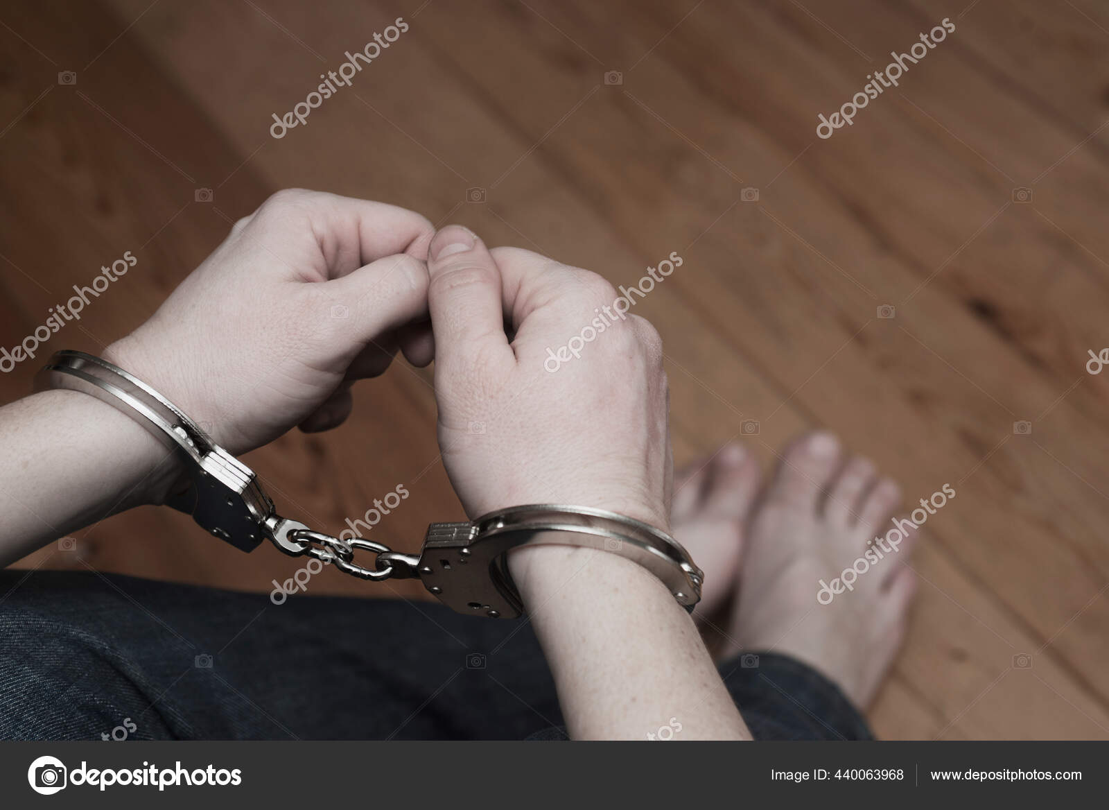 Man detained in handcuffs. Prisoner or arrested man in handcuffs. Male hands in handcuffs. Criminal law
