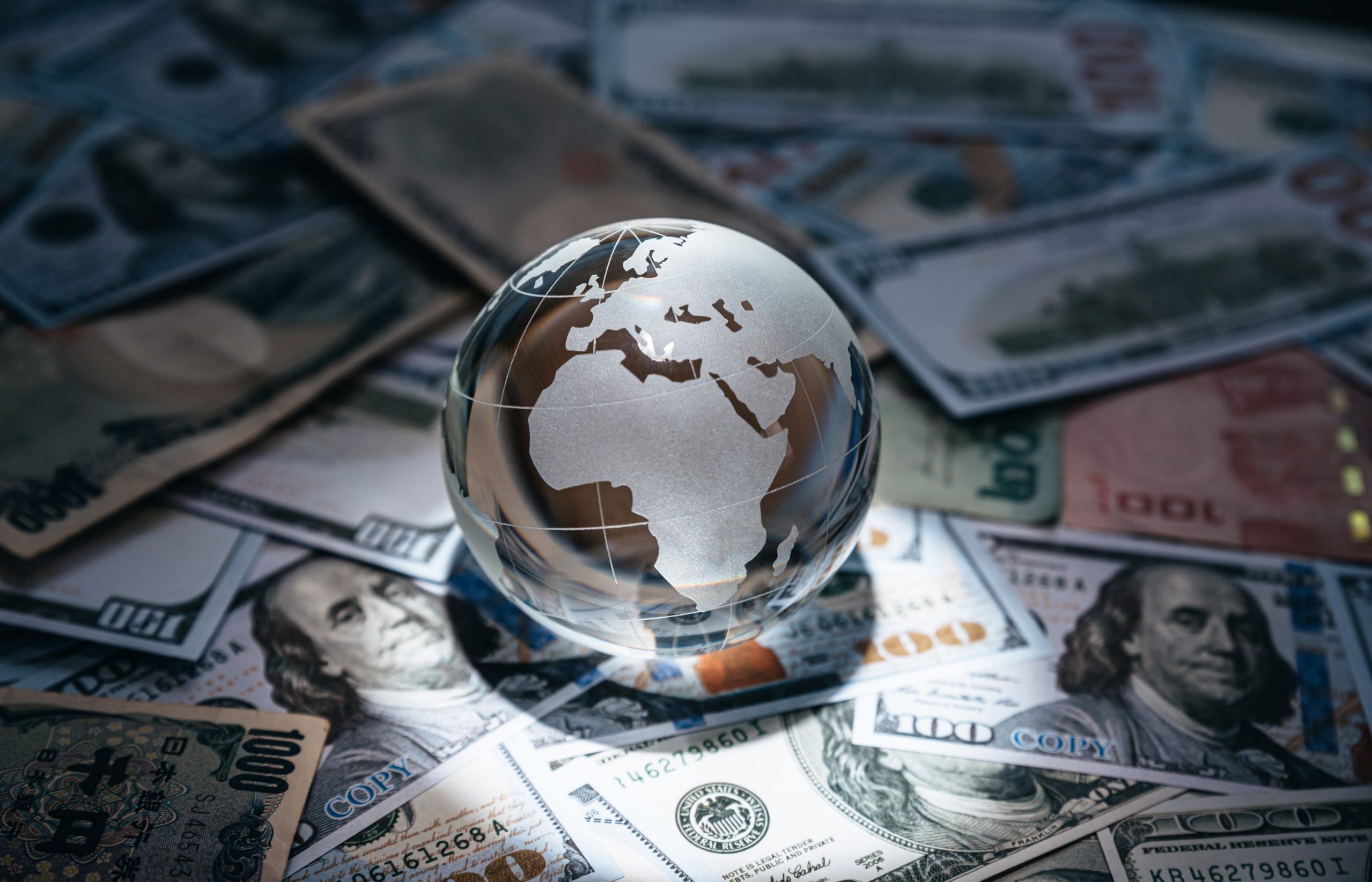 Crystal globe on many currency, World bank, Economic inflation conditions where tend to increase continuously.