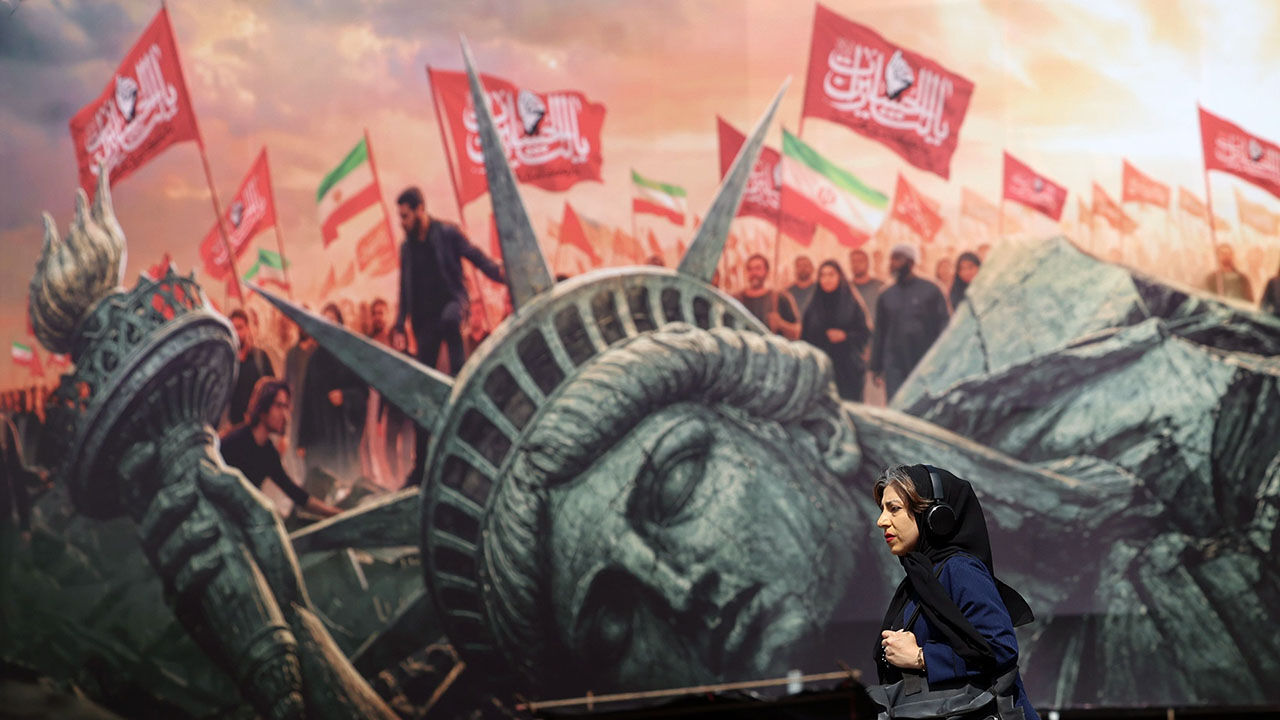 17069341d A woman walks past an anti-US bilboard in Tehran, Iran